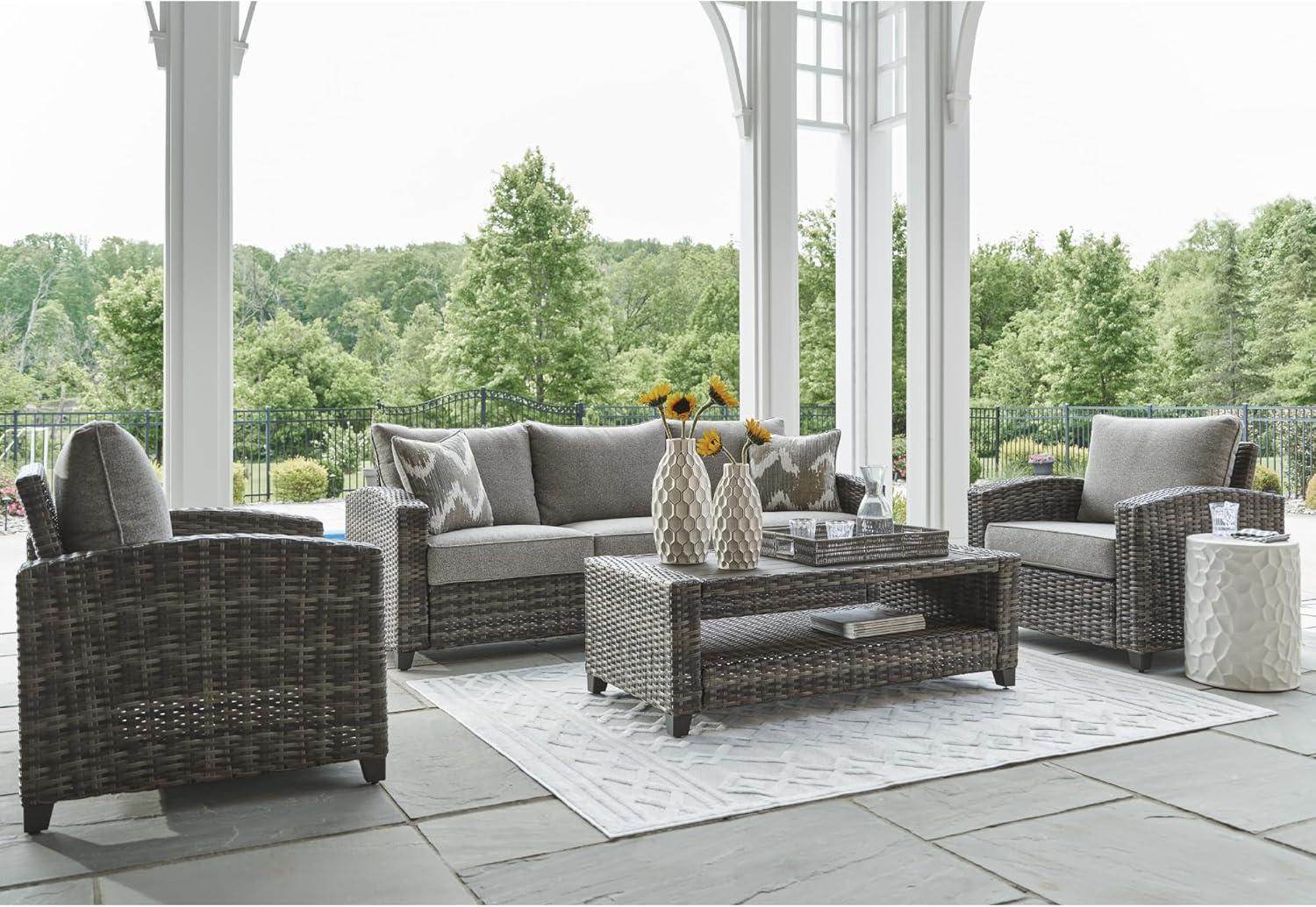 imageSignature Design by Ashley Oasis Court Casual Weather Resistant Cushioned Outdoor SofaChairsTable Set with 2 Throw Pillows Set of 4Nuvella Weather Resistant Fabric Gray