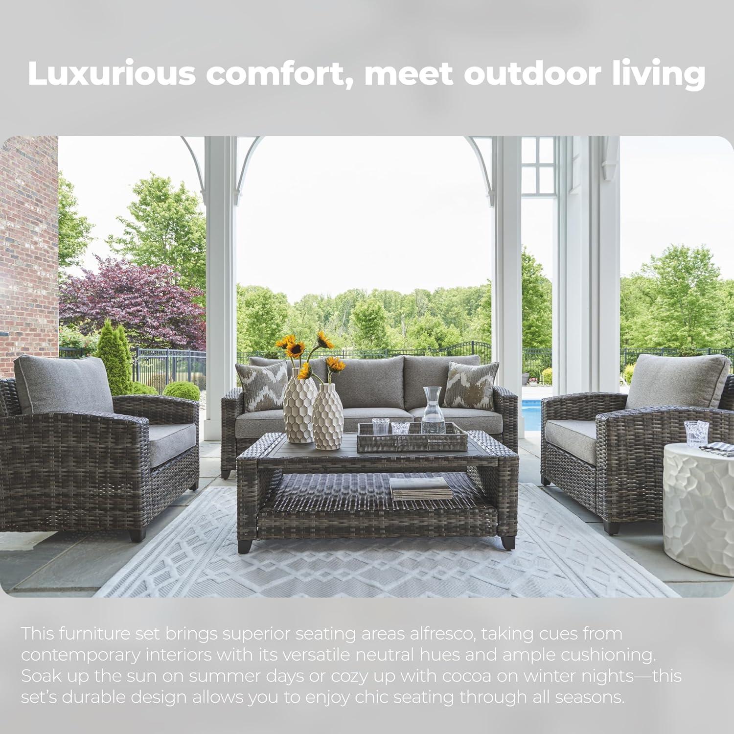 imageSignature Design by Ashley Oasis Court Casual Weather Resistant Cushioned Outdoor SofaChairsTable Set with 2 Throw Pillows Set of 4Nuvella Weather Resistant Fabric Gray