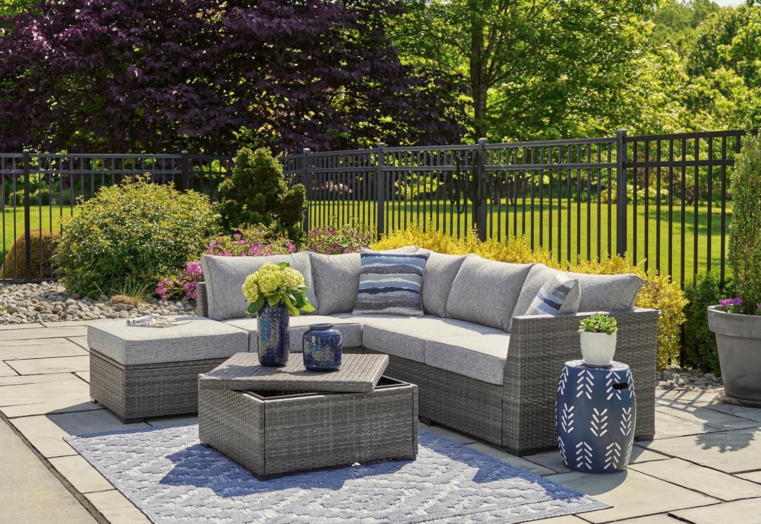 imageSignature Design by Ashley Petal Road Casual Nuvella Weather Resistant Fabric Cushioned Outdoor Loveseat SectionalOttomanTable Set with 2 Throw Pillows Set of 4 Gray