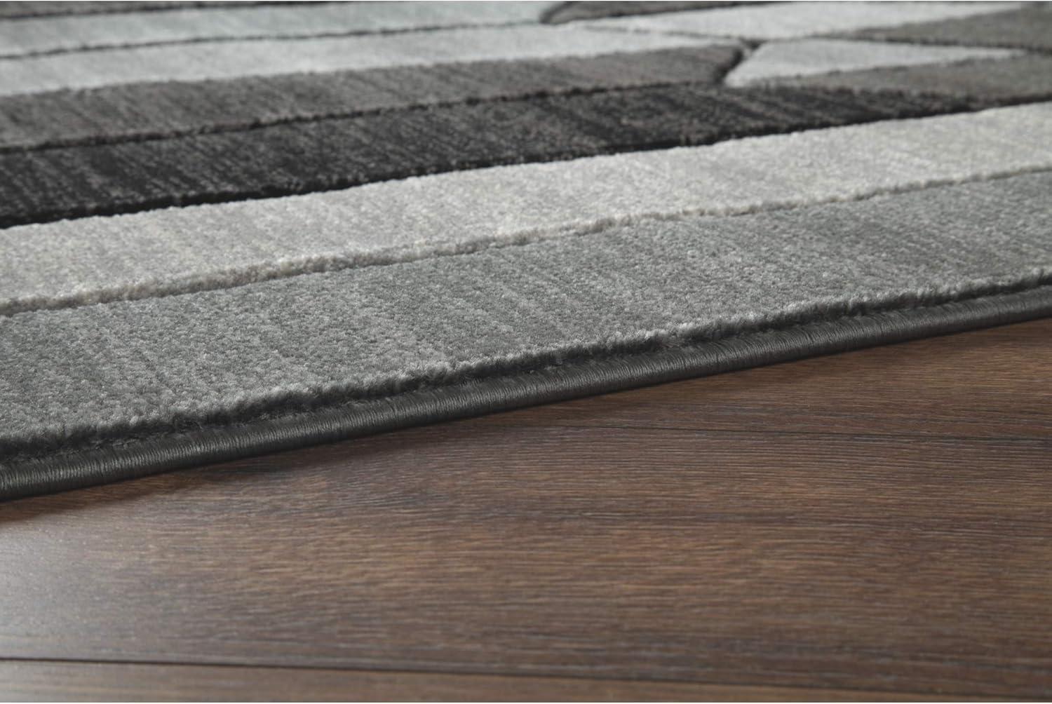 imageSignature Design by Ashley Chayse Urban 5 x 7 Medium Pile Rug with Hand Carved Detailing Black ampamp Gray5 x 67 Rectangular