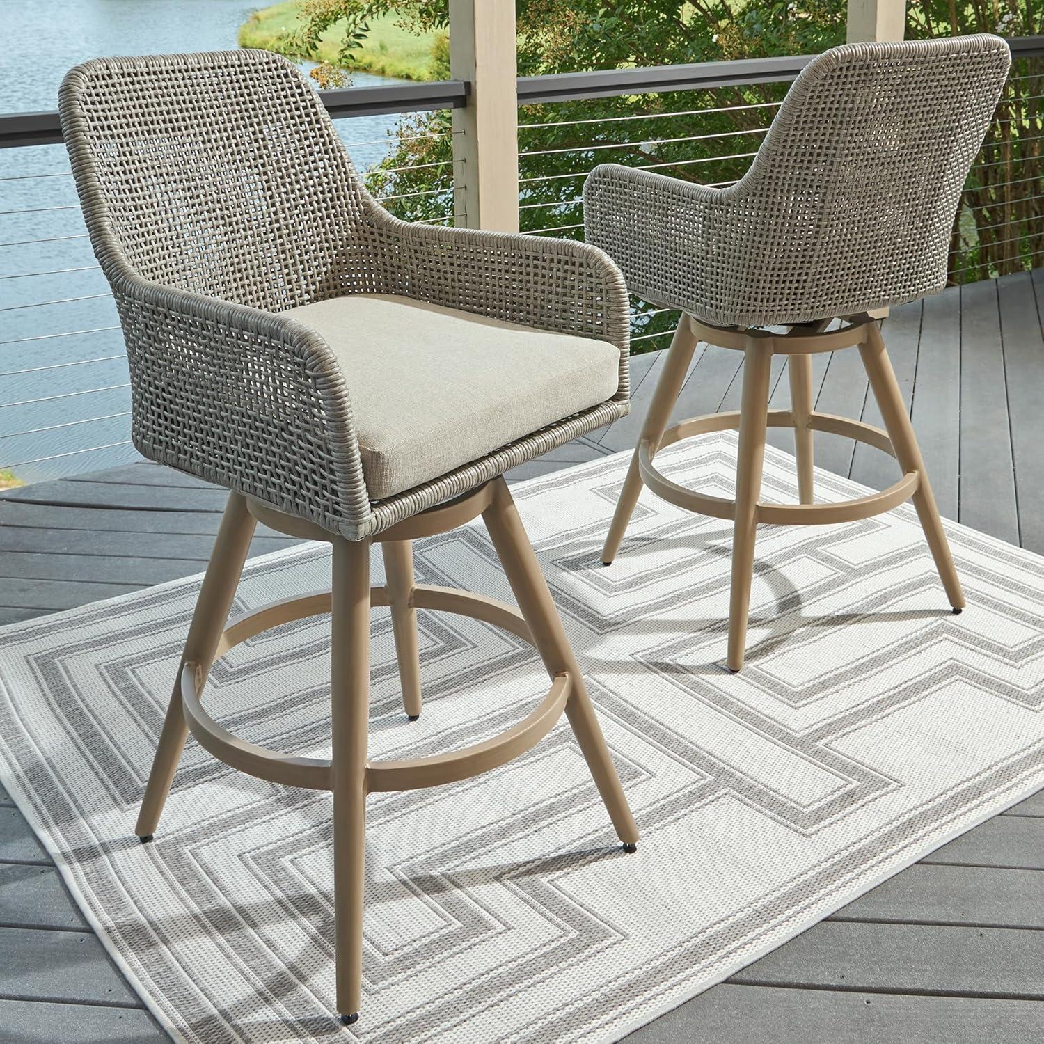 imageSignature Design by Ashley Seton Creek Casual Nuvella Weather Resistant Fabric Resin Wicker Swivel Outdoor Bar Height Bar Stool with Cushion Footrest and Armrest Set of 2 Beige ampamp Light Gray