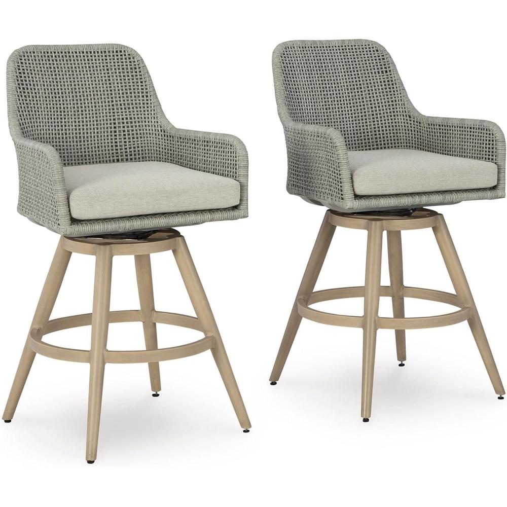 imageSignature Design by Ashley Seton Creek Casual Nuvella Weather Resistant Fabric Resin Wicker Swivel Outdoor Bar Height Bar Stool with Cushion Footrest and Armrest Set of 2 Beige ampamp Light Gray